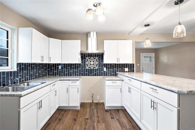 kitchen featuring backsplash, sink, dark hardwood / wood-style floors, white cabinetry, and hanging light fixtures