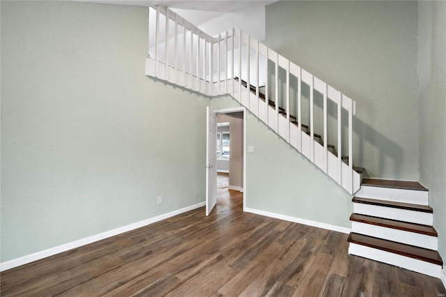 stairway with hardwood / wood-style floors