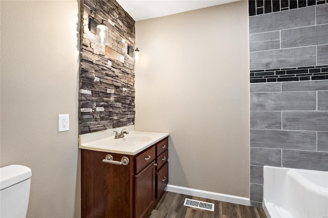 bathroom featuring hardwood / wood-style floors, vanity, and toilet