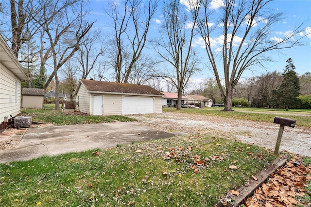 view of yard with a garage and an outdoor structure