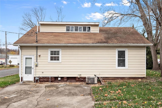 rear view of property featuring a patio and central AC