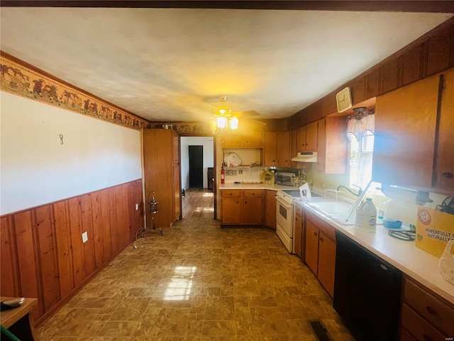 kitchen with ceiling fan, sink, black dishwasher, white stove, and wood walls