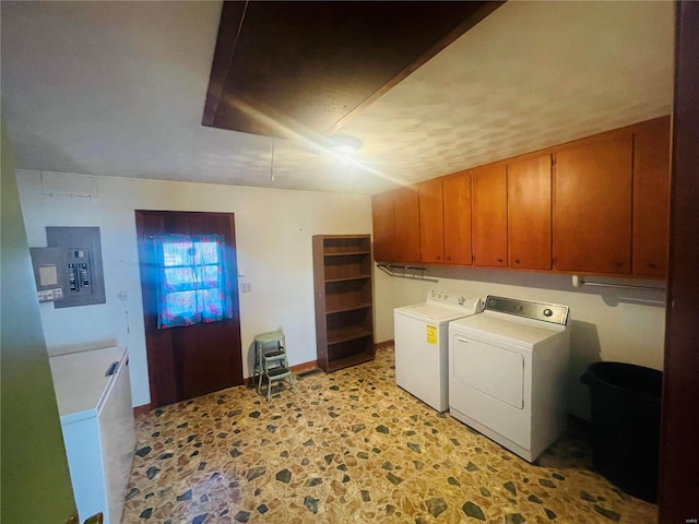 laundry room featuring cabinets, electric panel, and separate washer and dryer