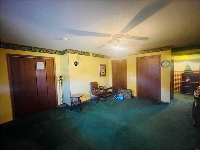 interior space featuring ceiling fan and two closets