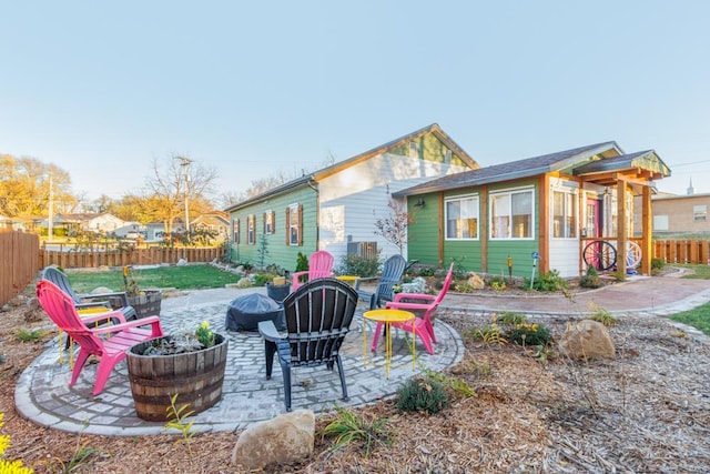 back of house with a patio area and an outdoor fire pit