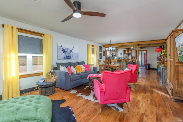 living room featuring hardwood / wood-style floors and ceiling fan