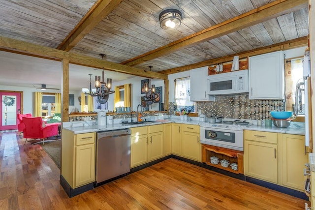 kitchen with light hardwood / wood-style floors, white appliances, sink, and a wealth of natural light