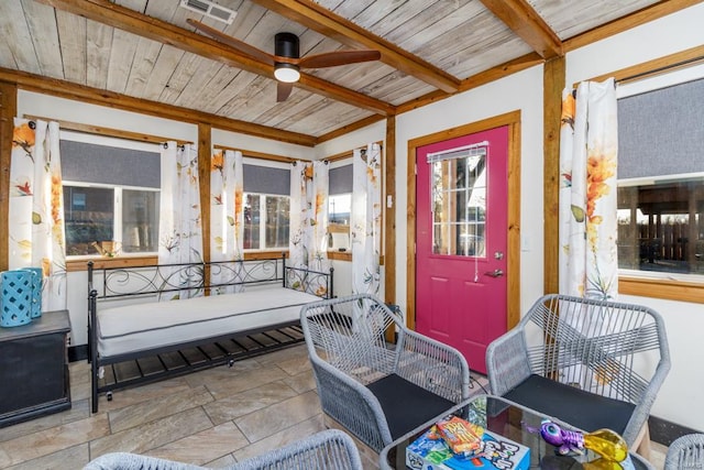 view of exterior entry featuring ceiling fan and covered porch