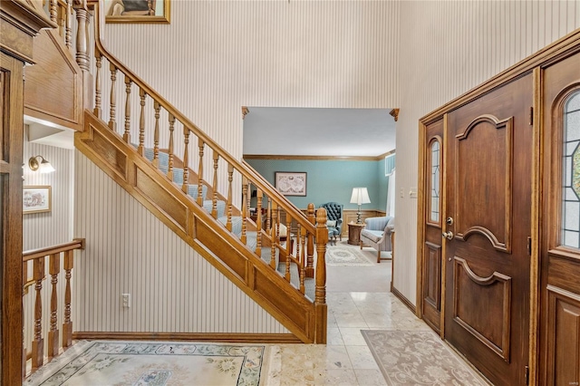 foyer featuring ornamental molding