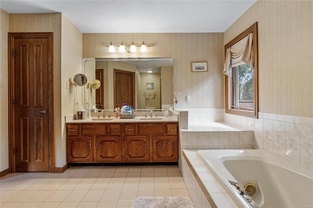 bathroom with tile patterned flooring, vanity, and a relaxing tiled tub