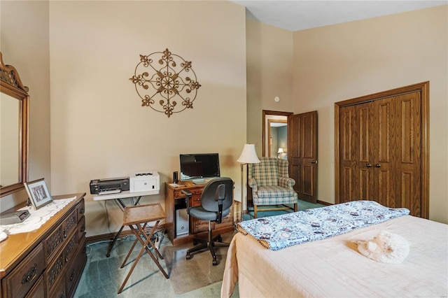 bedroom with carpet flooring and a towering ceiling