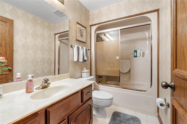 full bathroom with tile patterned floors, toilet, vanity, and combined bath / shower with glass door