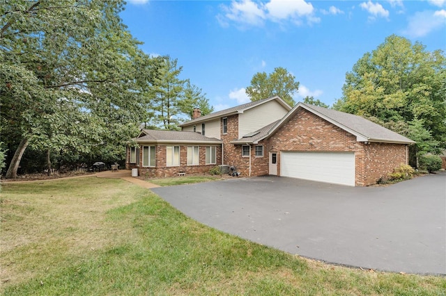 front of property with a front yard and a garage