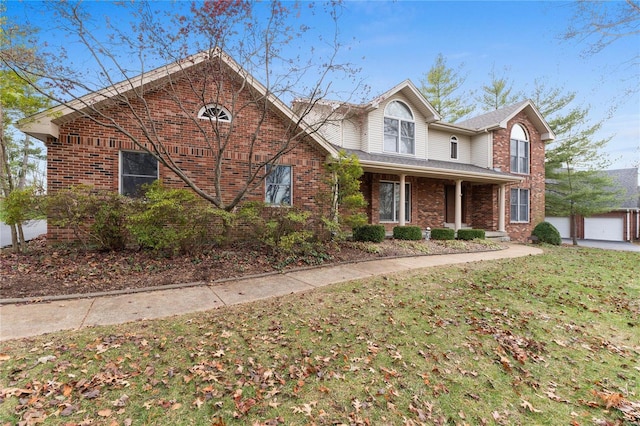 view of front property with a front yard, a garage, and an outdoor structure