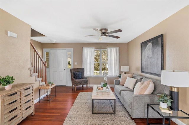 living room featuring ceiling fan and dark hardwood / wood-style floors