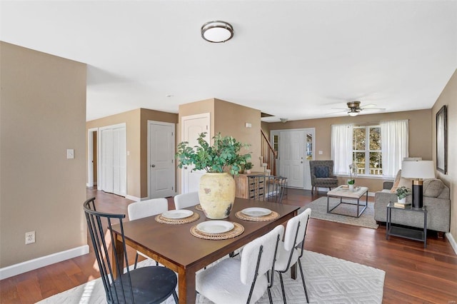 dining area with ceiling fan and dark hardwood / wood-style floors