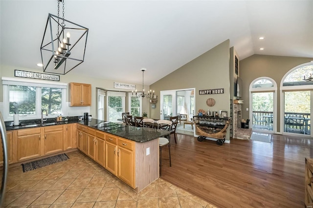 kitchen featuring a kitchen bar, kitchen peninsula, and a wealth of natural light