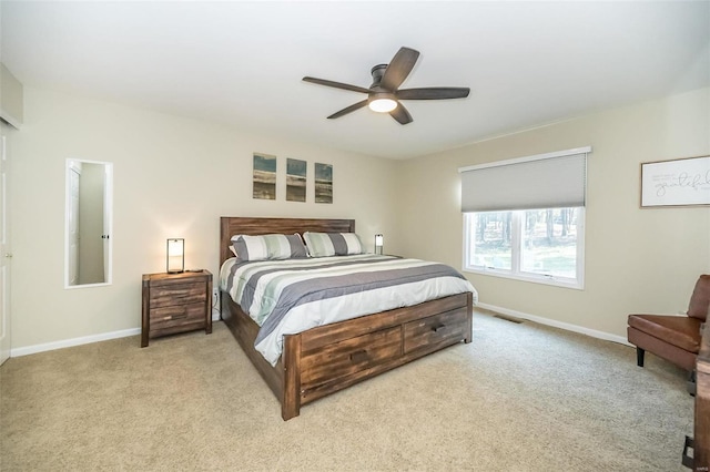 bedroom with ceiling fan and light carpet