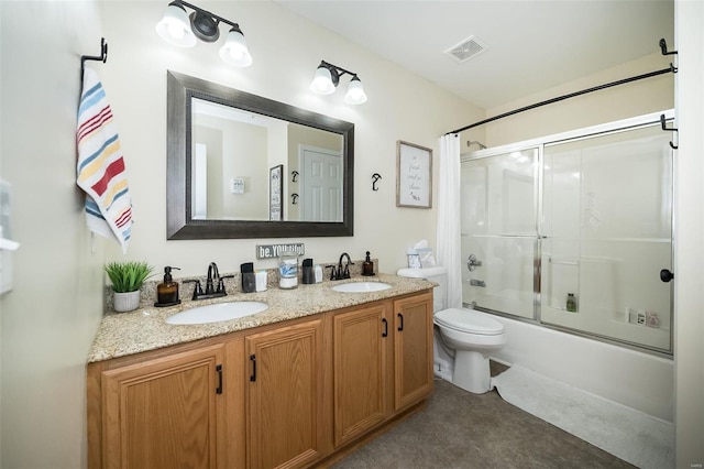 full bathroom with vanity, toilet, and bath / shower combo with glass door