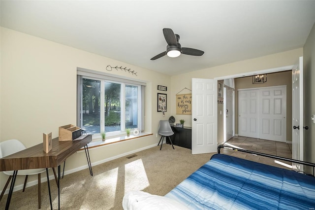 bedroom featuring carpet, ceiling fan with notable chandelier, and a closet