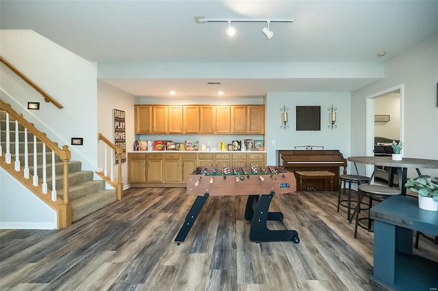 playroom with dark wood-type flooring