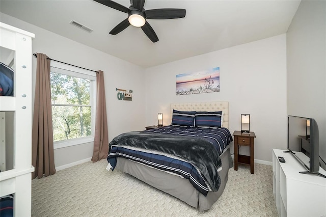 bedroom with ceiling fan and light colored carpet