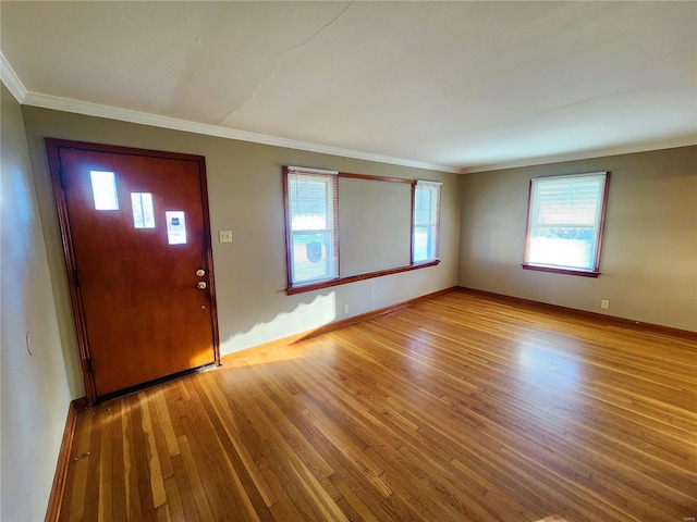 entrance foyer with crown molding and wood-type flooring