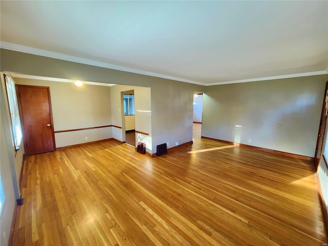 spare room with light hardwood / wood-style floors and ornamental molding