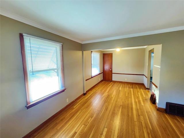 unfurnished room featuring crown molding and light hardwood / wood-style floors