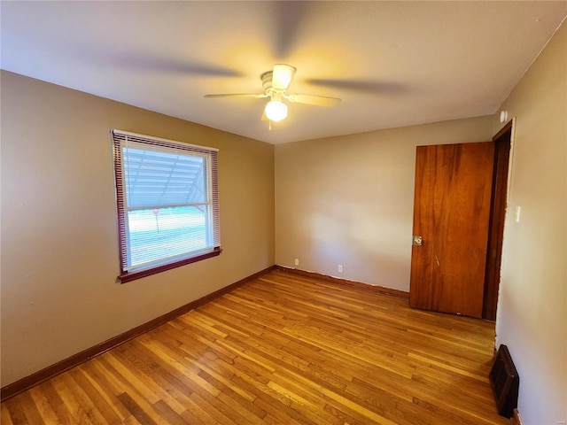 empty room with light hardwood / wood-style floors and ceiling fan