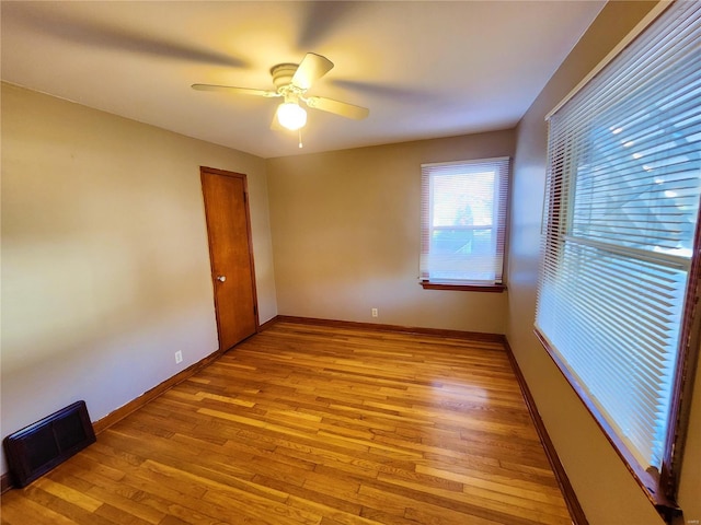 unfurnished room featuring ceiling fan and light wood-type flooring