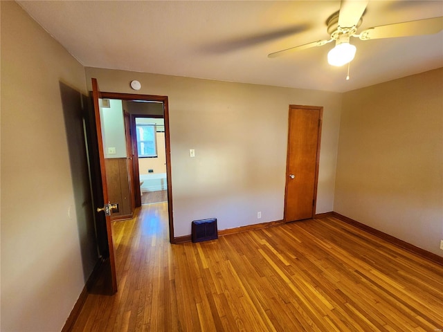 empty room featuring ceiling fan and light hardwood / wood-style floors