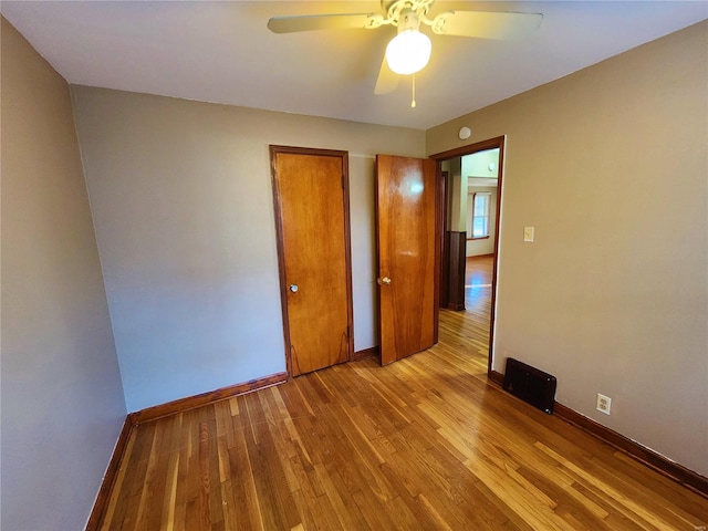 unfurnished bedroom featuring ceiling fan and light wood-type flooring