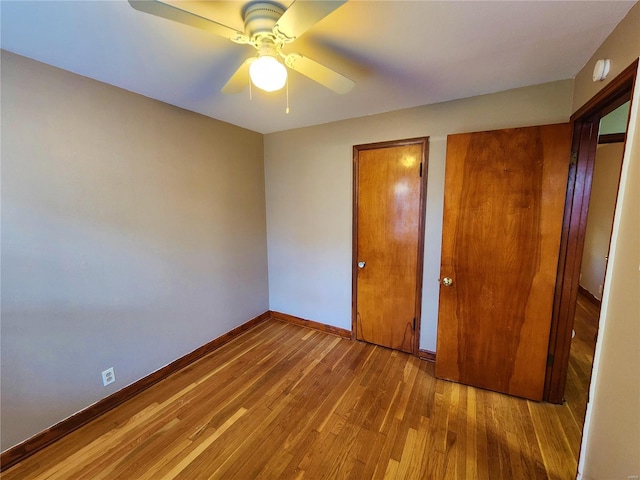 unfurnished bedroom featuring ceiling fan and hardwood / wood-style flooring