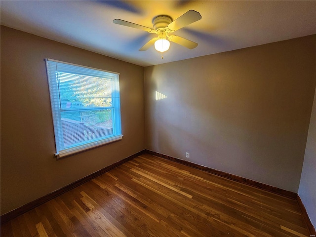 spare room featuring ceiling fan and dark wood-type flooring