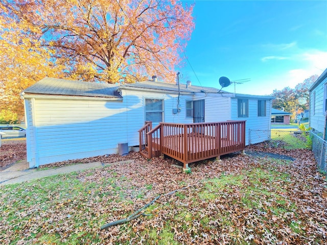 rear view of property featuring a wooden deck