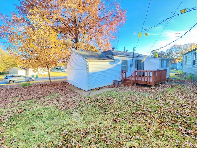 back of house with a wooden deck