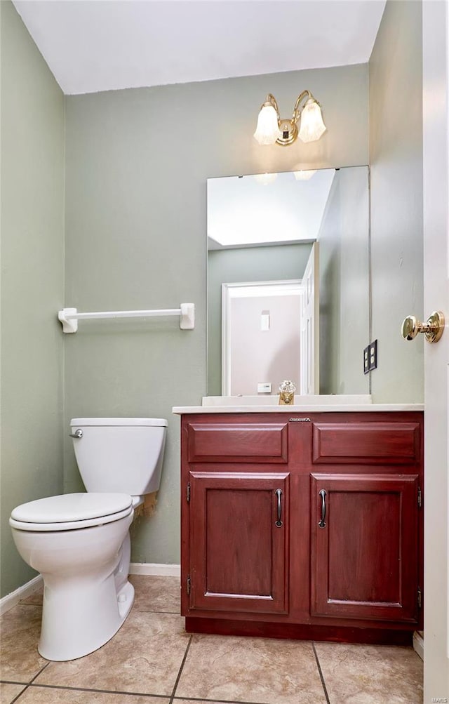 bathroom featuring tile patterned flooring, vanity, and toilet