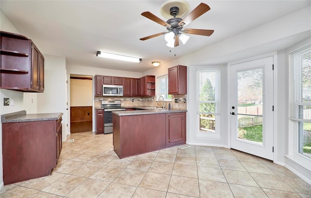 kitchen with tasteful backsplash, stainless steel appliances, a wealth of natural light, and sink