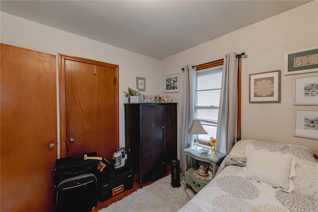 bedroom with light carpet and a closet