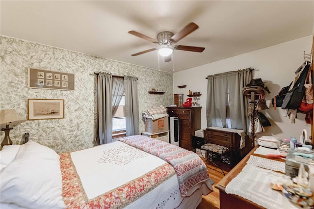 bedroom with hardwood / wood-style floors and ceiling fan