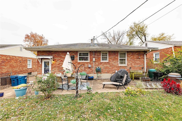 back of house featuring a yard and a patio