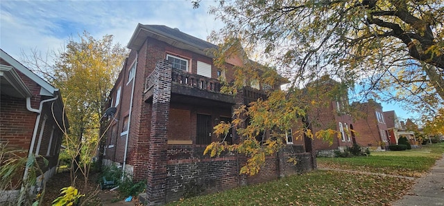 view of property exterior with a balcony and a yard