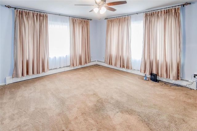 carpeted spare room featuring ceiling fan