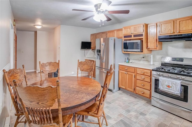 kitchen featuring ceiling fan, light brown cabinetry, and appliances with stainless steel finishes