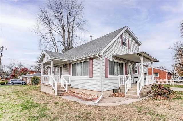 view of front of property with covered porch and a front yard