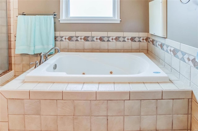 bathroom featuring tiled tub