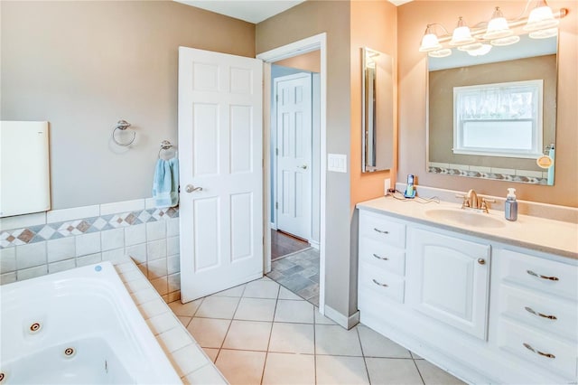 bathroom with a bath, vanity, and tile patterned floors