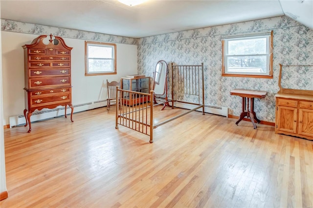 bedroom with light hardwood / wood-style floors, multiple windows, and lofted ceiling