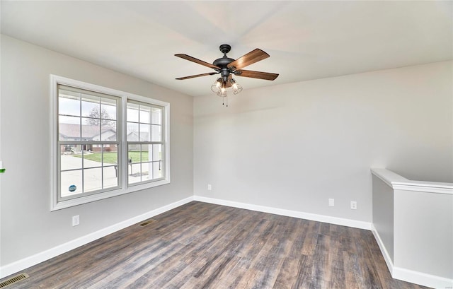 unfurnished room with ceiling fan and dark wood-type flooring